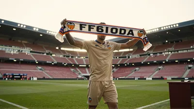 Kayne van Oevelen, 22, in a plain white goalkeeper jersey and shorts, intense focus, gloves gripping a slightly wet...