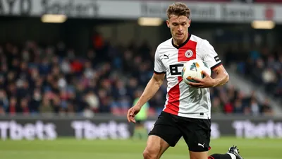 A photorealistic image of a 20-year-old FC Volendam midfielder, wearing a white jersey with a red stripe, a pair of black...