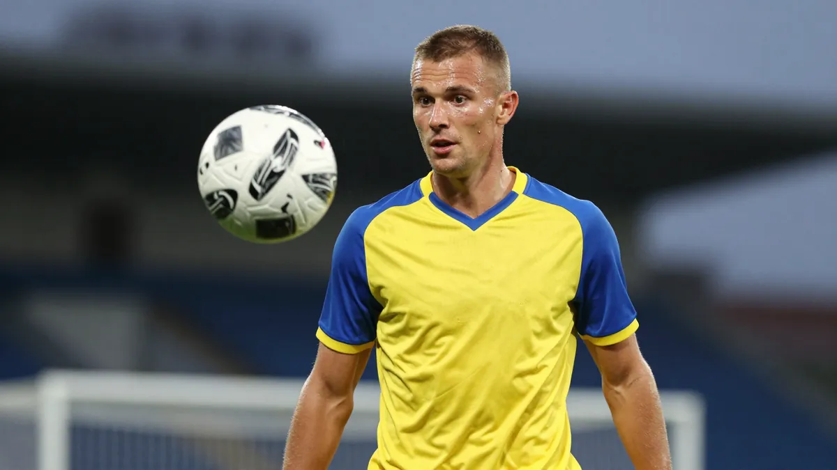 A photorealistic image of an anonymous 28-year-old middenvelder with a short haircut, wearing a yellow and blue jersey...